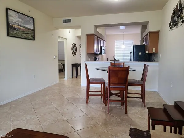 a living room with furniture and floor to ceiling window