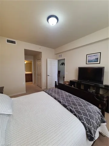 a bedroom with a bed and dresser