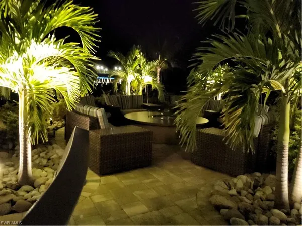a view of a swimming pool with seating space