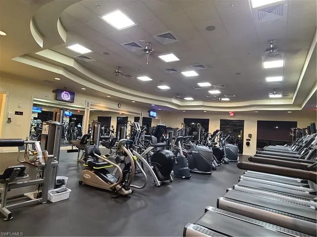a backyard of a house with table and chairs potted plants