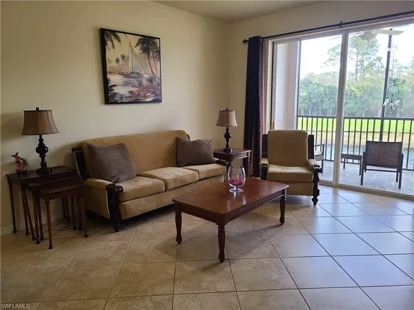 a living room with furniture a dining table and a potted plant