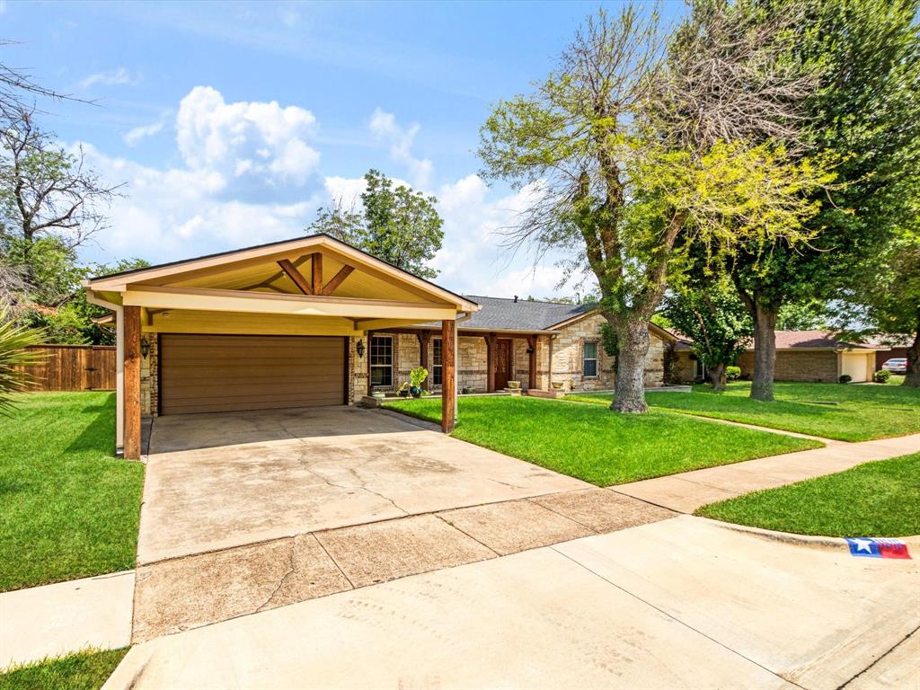 1616 Springbrook Street Mesquite, TX 75149 - Photo 20 of 24 Stone facade with a prominent carport featuring wood-beamed accents