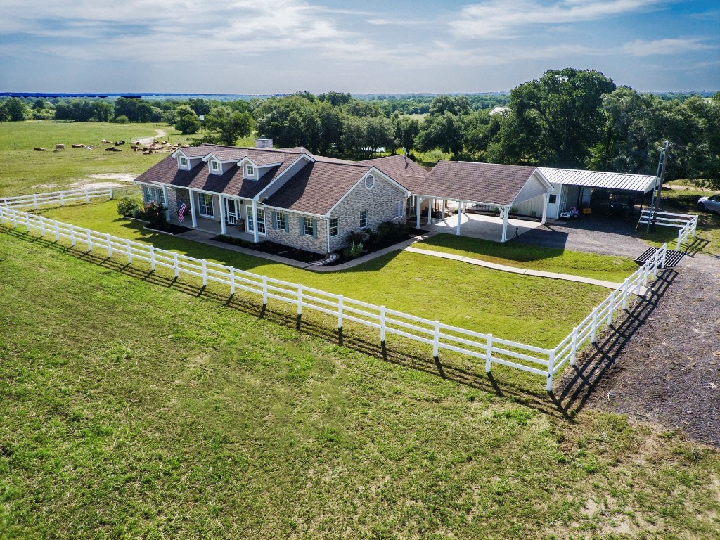 an aerial view of a house with a yard