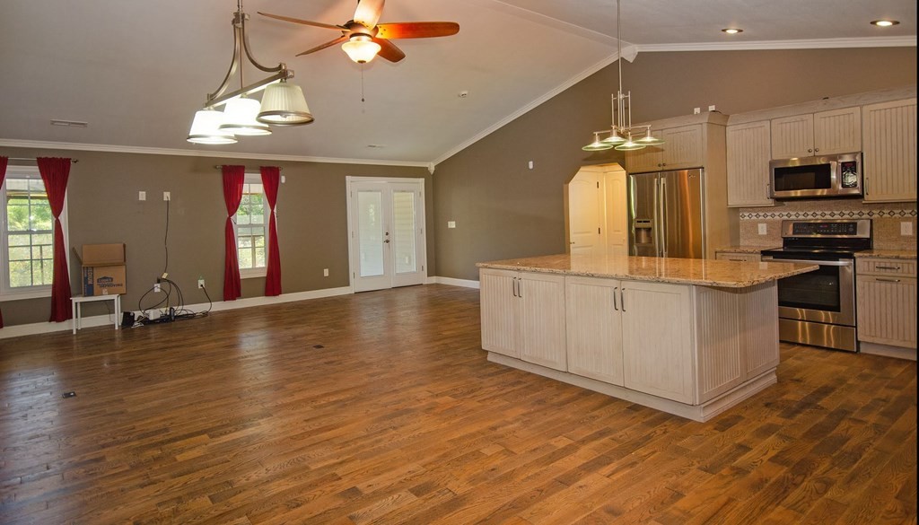 767 Lane Hollow Road Sevierville, TN 37876 - Photo 8 of 31 an open kitchen with a sink and dishwasher with a large kitchen island