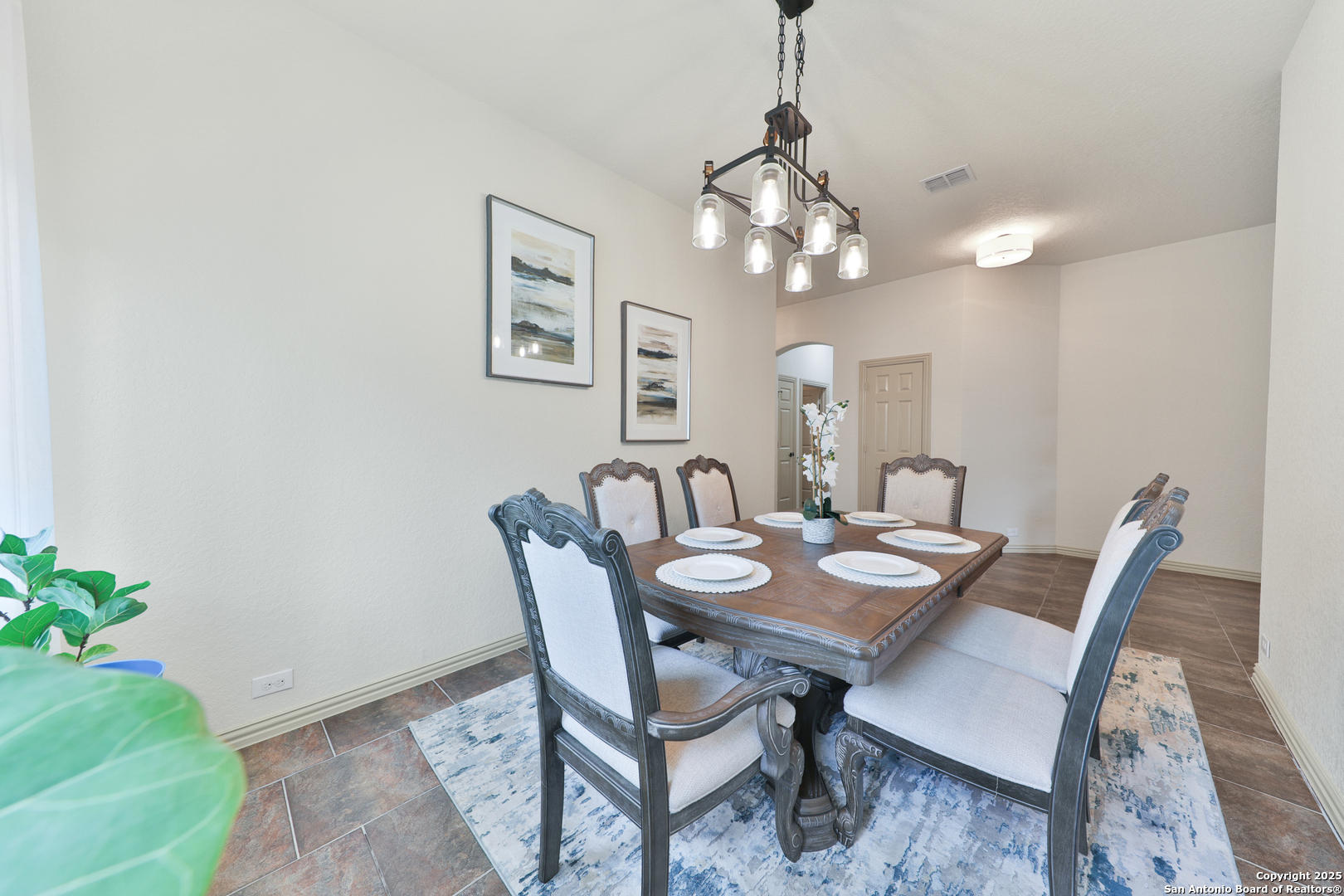 10811 Newcroft Place Helotes, TX 78023 - Photo 15 of 52 a view of a dining room with furniture and wooden floor