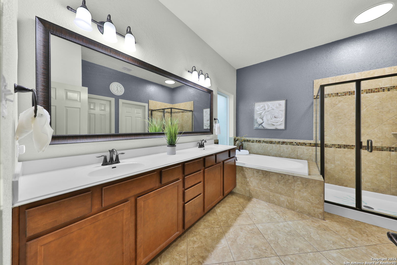 10811 Newcroft Place Helotes, TX 78023 - Photo 24 of 52 a spacious bathroom with a tub sink and mirror