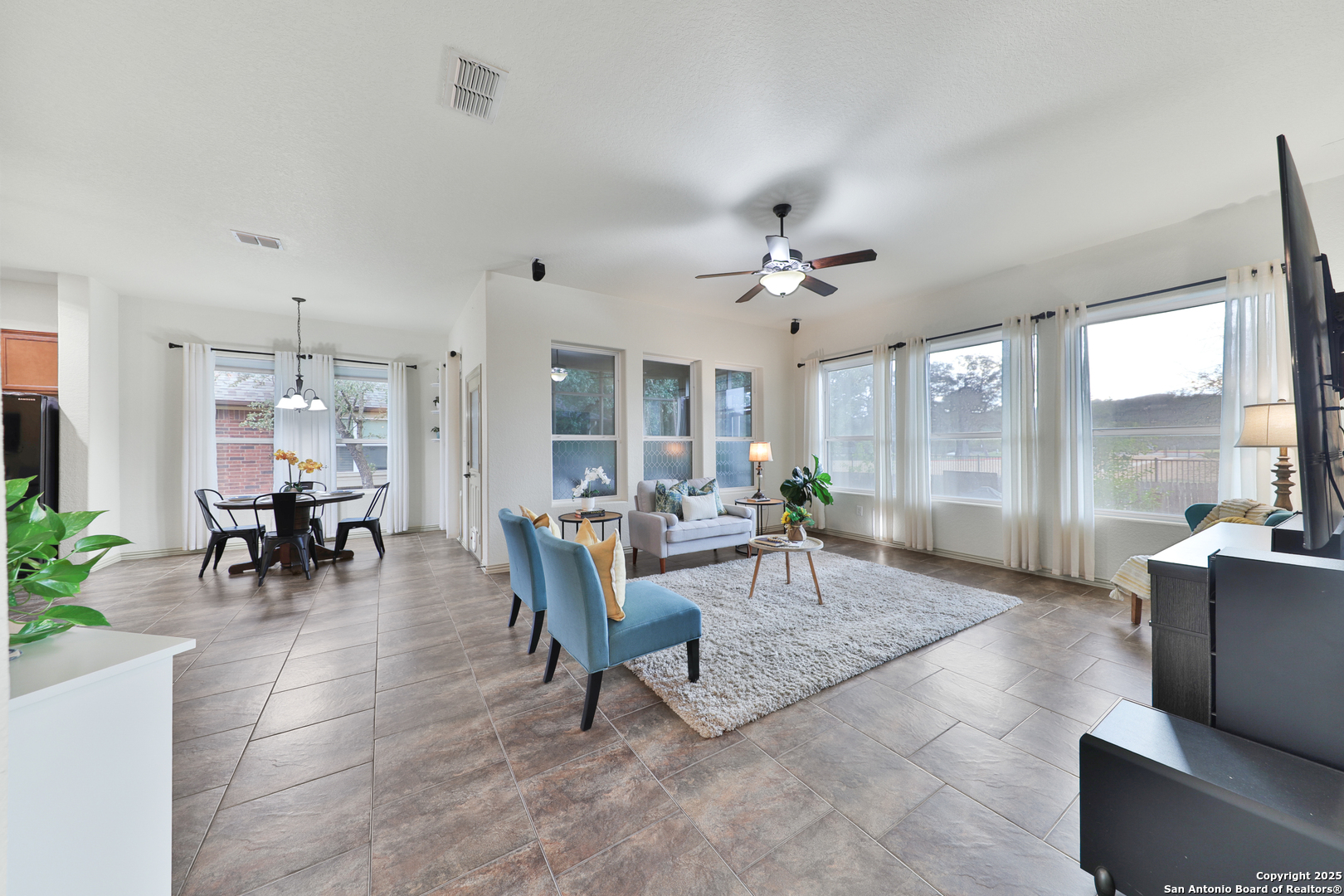 10811 Newcroft Place Helotes, TX 78023 - Photo 29 of 52 a living room with furniture and a large window