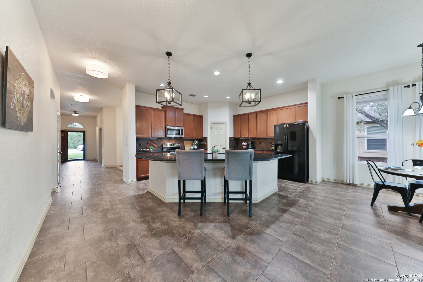 10811 Newcroft Place Helotes, TX 78023 - Photo 33 of 52 a view of kitchen with dining table and chairs