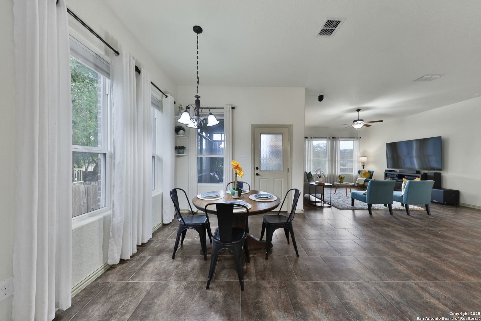 10811 Newcroft Place Helotes, TX 78023 - Photo 38 of 52 a view of a dining room with furniture window and wooden floor