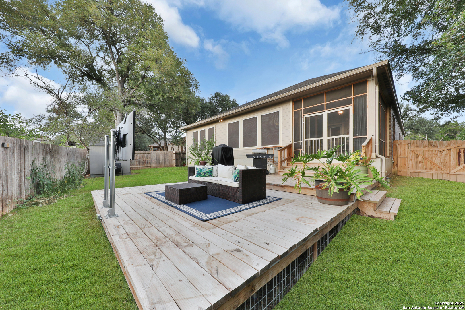 10811 Newcroft Place Helotes, TX 78023 - Photo 43 of 52 a view of a backyard with couches plants and large tree
