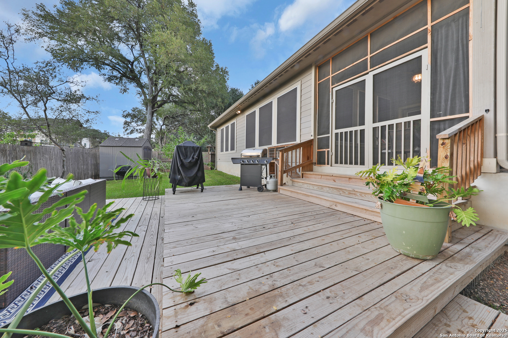 10811 Newcroft Place Helotes, TX 78023 - Photo 44 of 52 a view of a chair and table on the wooden deck