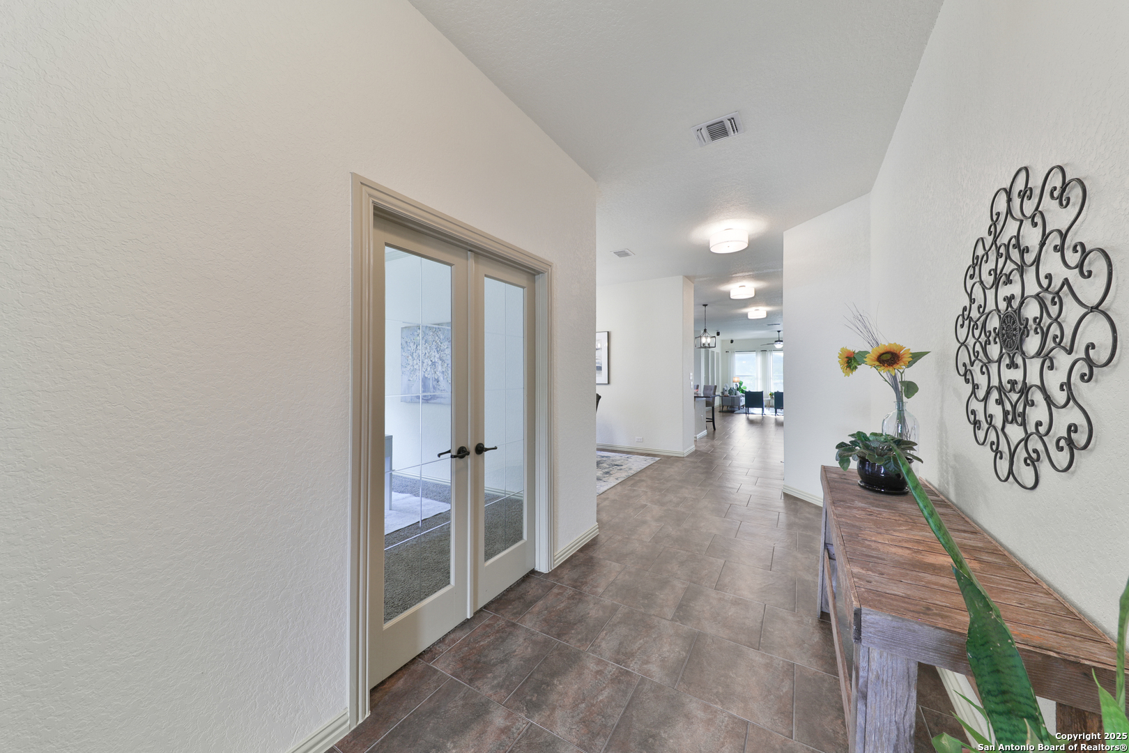 10811 Newcroft Place Helotes, TX 78023 - Photo 6 of 52 a view of a hallway with wooden shelves