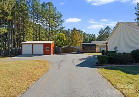 a front view of a house with a yard and a garage