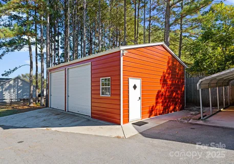 a backyard of a house with oven and tree