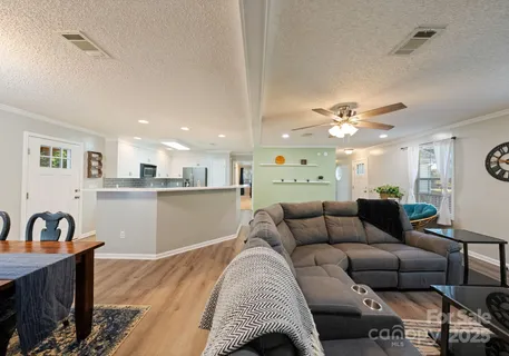 a living room with furniture and kitchen view