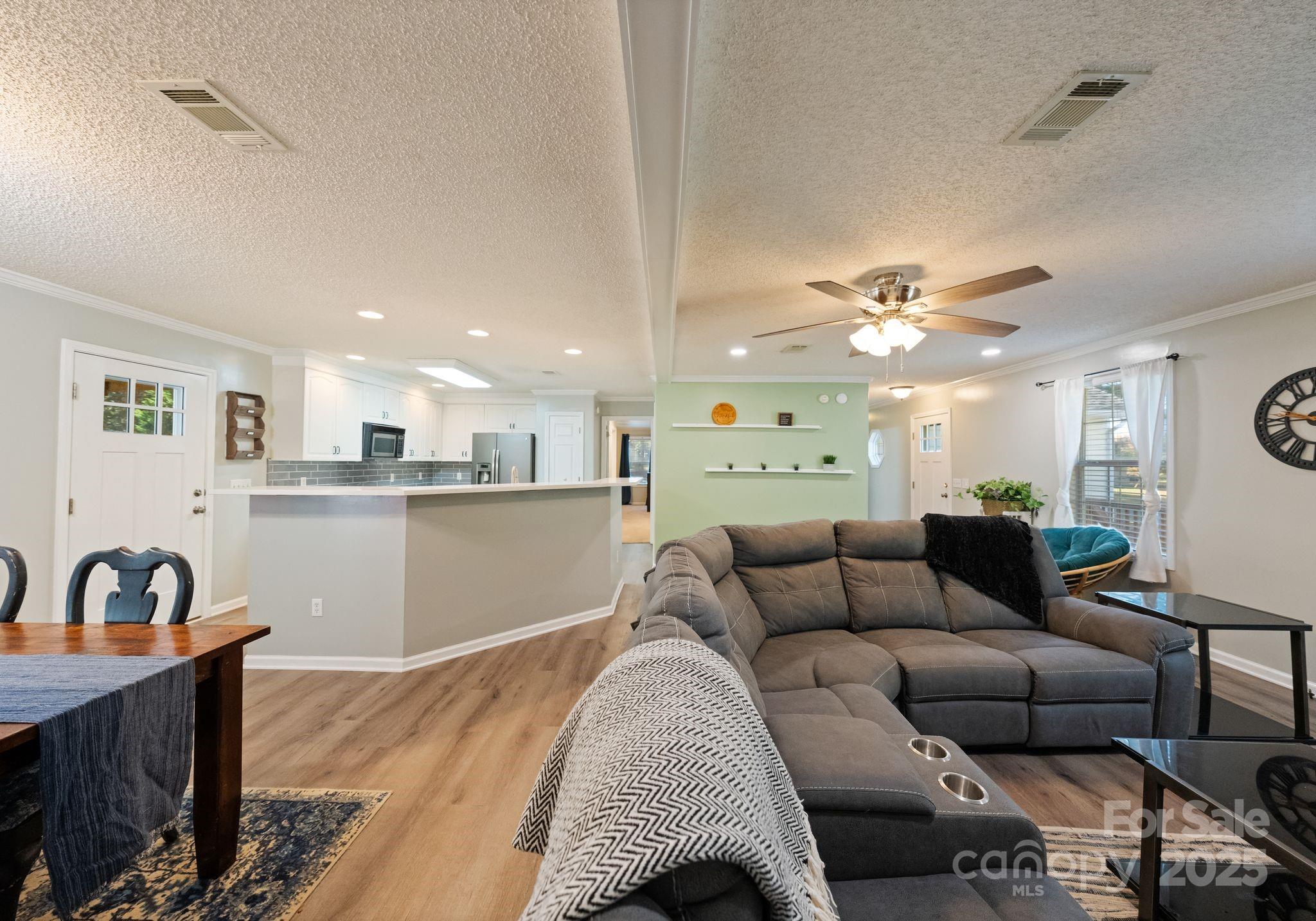 9951 Barnett Road Concord, NC 28027 - Photo 3 of 22 a living room with furniture and kitchen view