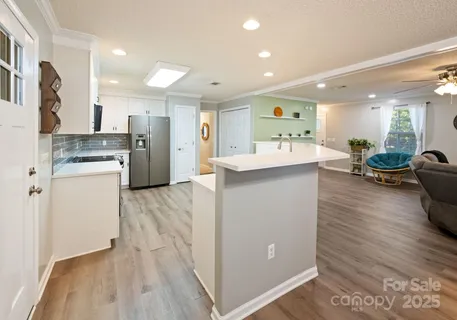 a kitchen with stainless steel appliances granite countertop a refrigerator and a stove top oven