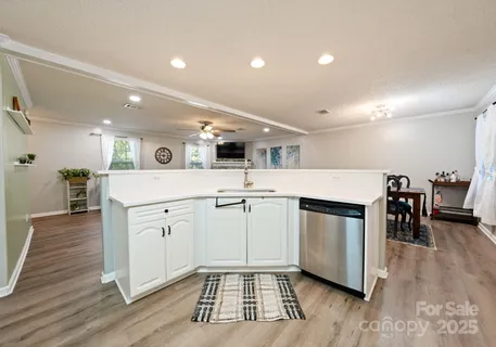 a kitchen with cabinets and wooden floor