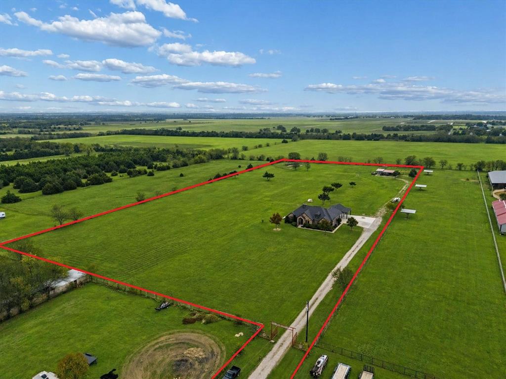 542 Pierce Road Red Oak, TX 75154 - Photo 3 of 27 Expansive acreage featuring a private drive, a large single-story residence with a dark roof, and multiple outbuildings