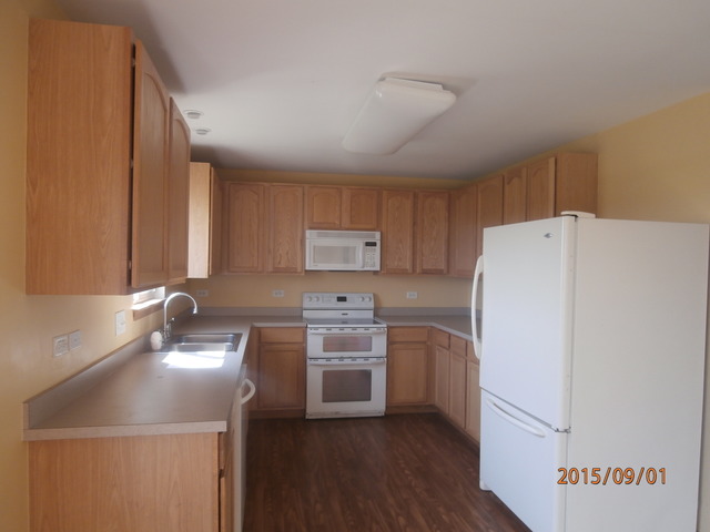 640 Halfway Road Bourbonnais, IL 60914 - Photo 4 of 15 a kitchen with a sink a refrigerator and cabinets
