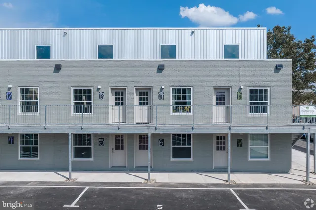 a front view of a house with a parking space
