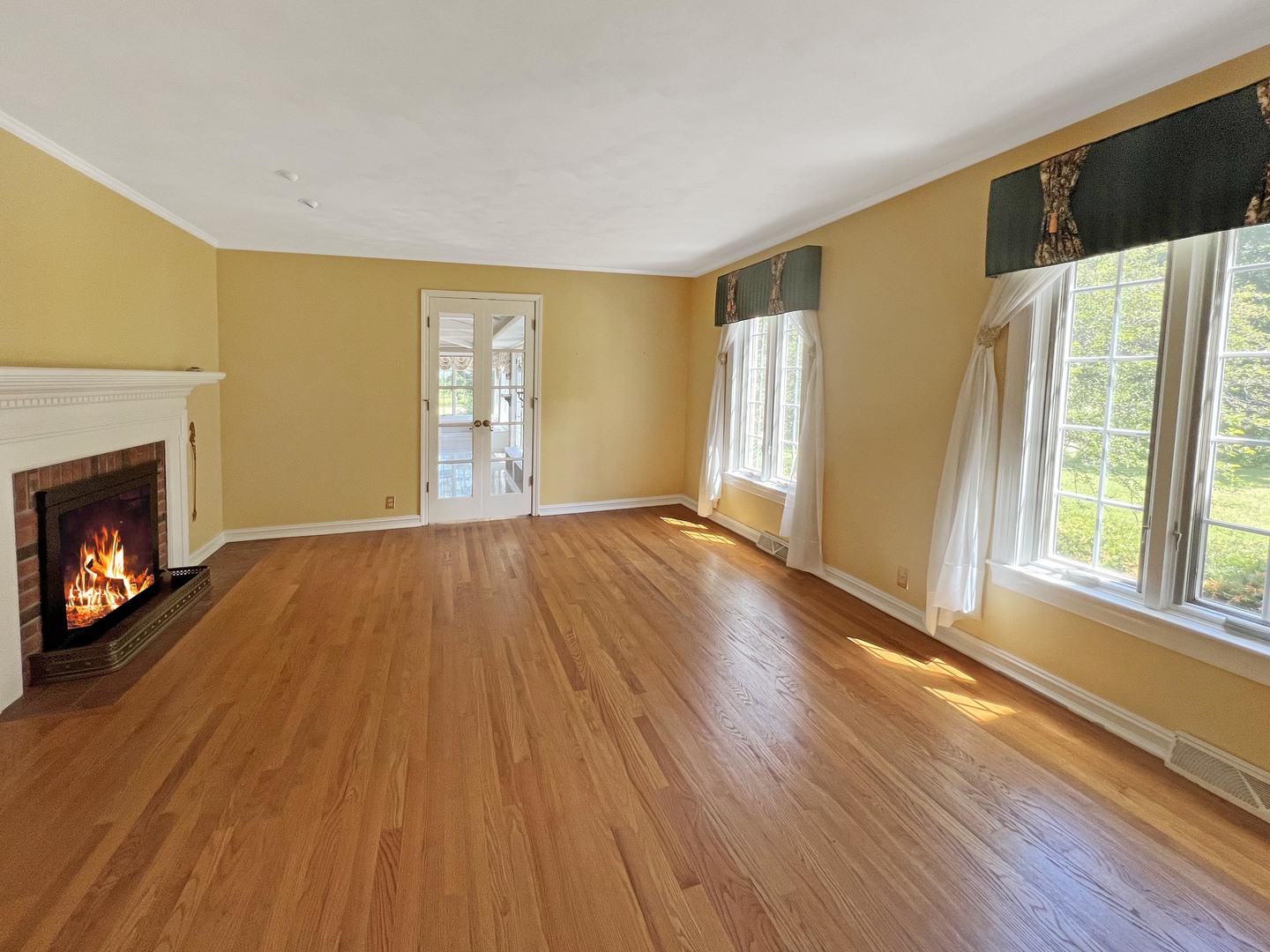 1017 Fisk Road Compton, IL 61318 - Photo 20 of 60 a view of an empty room with wooden floor fireplace and a window