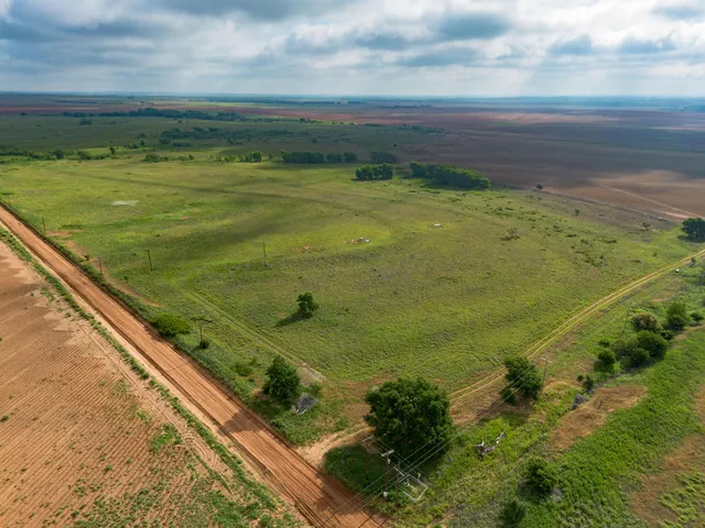a view of a green field with an ocean