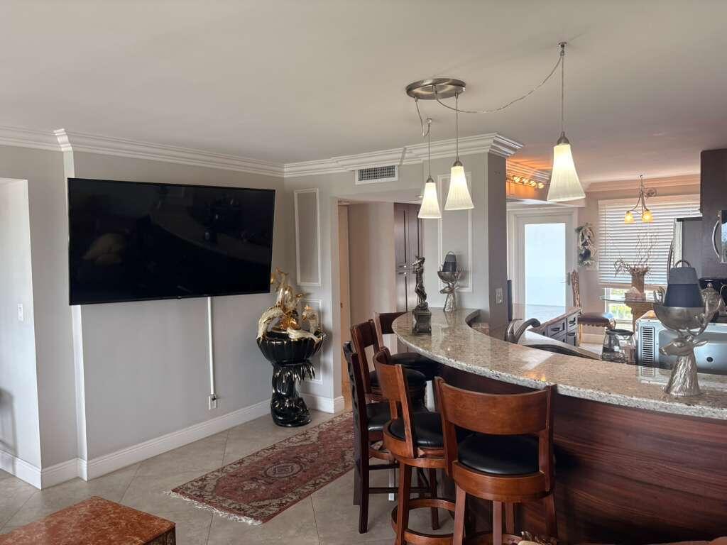 2611 North Riverside Drive, Unit 703 Pompano Beach, FL 33062 - Photo 17 of 81 a room with a table chairs and entryway