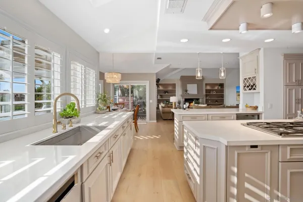 a large kitchen with stainless steel appliances kitchen island granite countertop a large counter top and sink