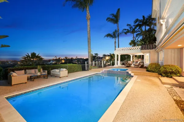 a view of a swimming pool with lounge chairs