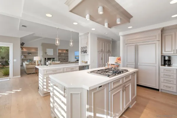 a kitchen that has a stove a table and chairs in it
