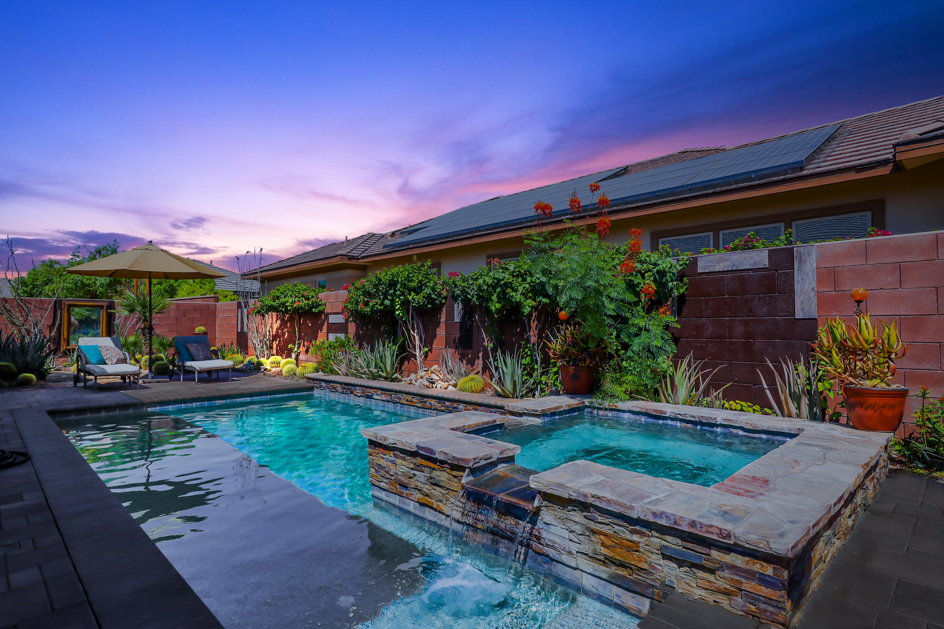a view of a backyard with plants and a patio