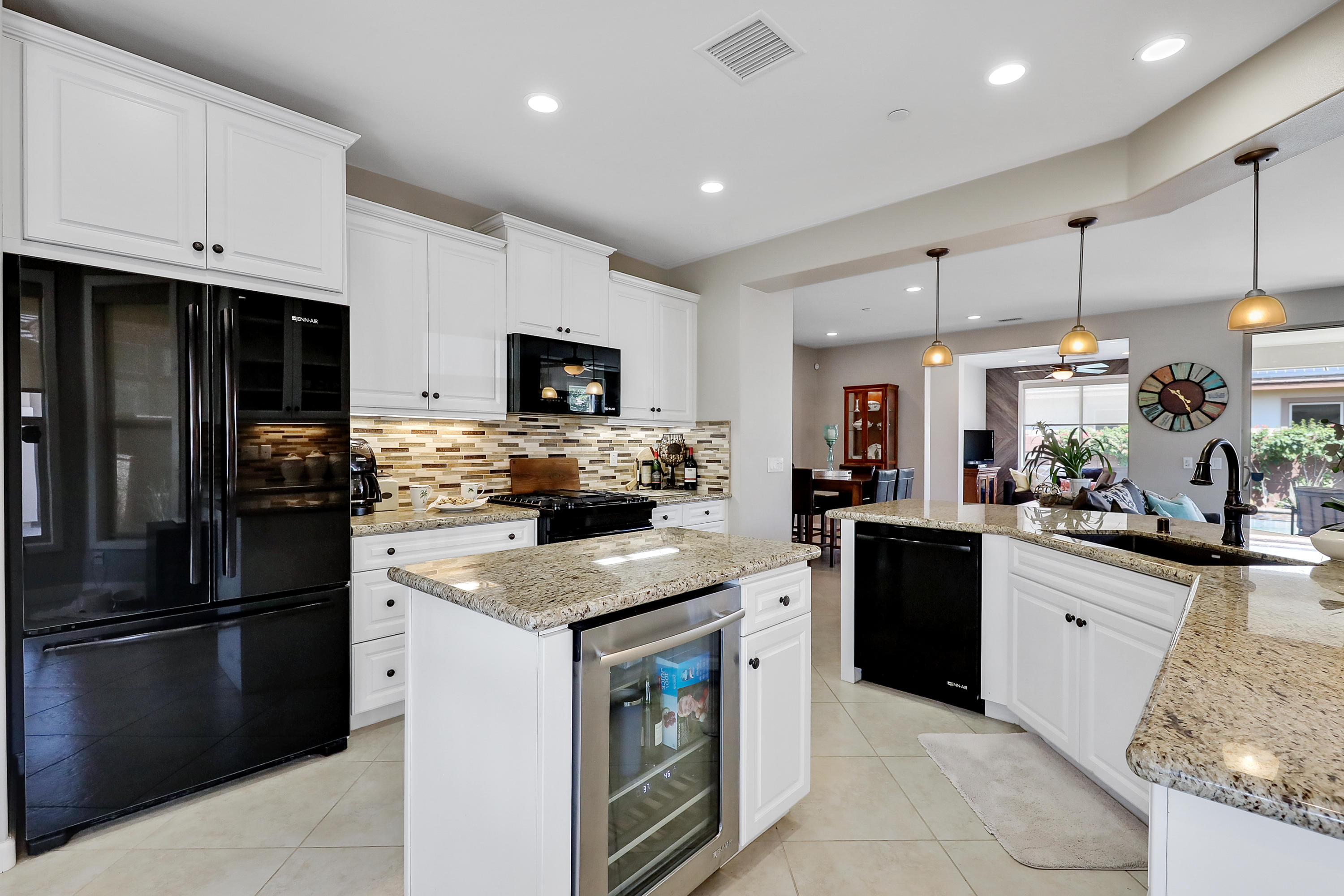 82782 Kingsboro Lane Indio, CA 92201 - Photo 2 of 39 a kitchen with cabinets and stainless steel appliances