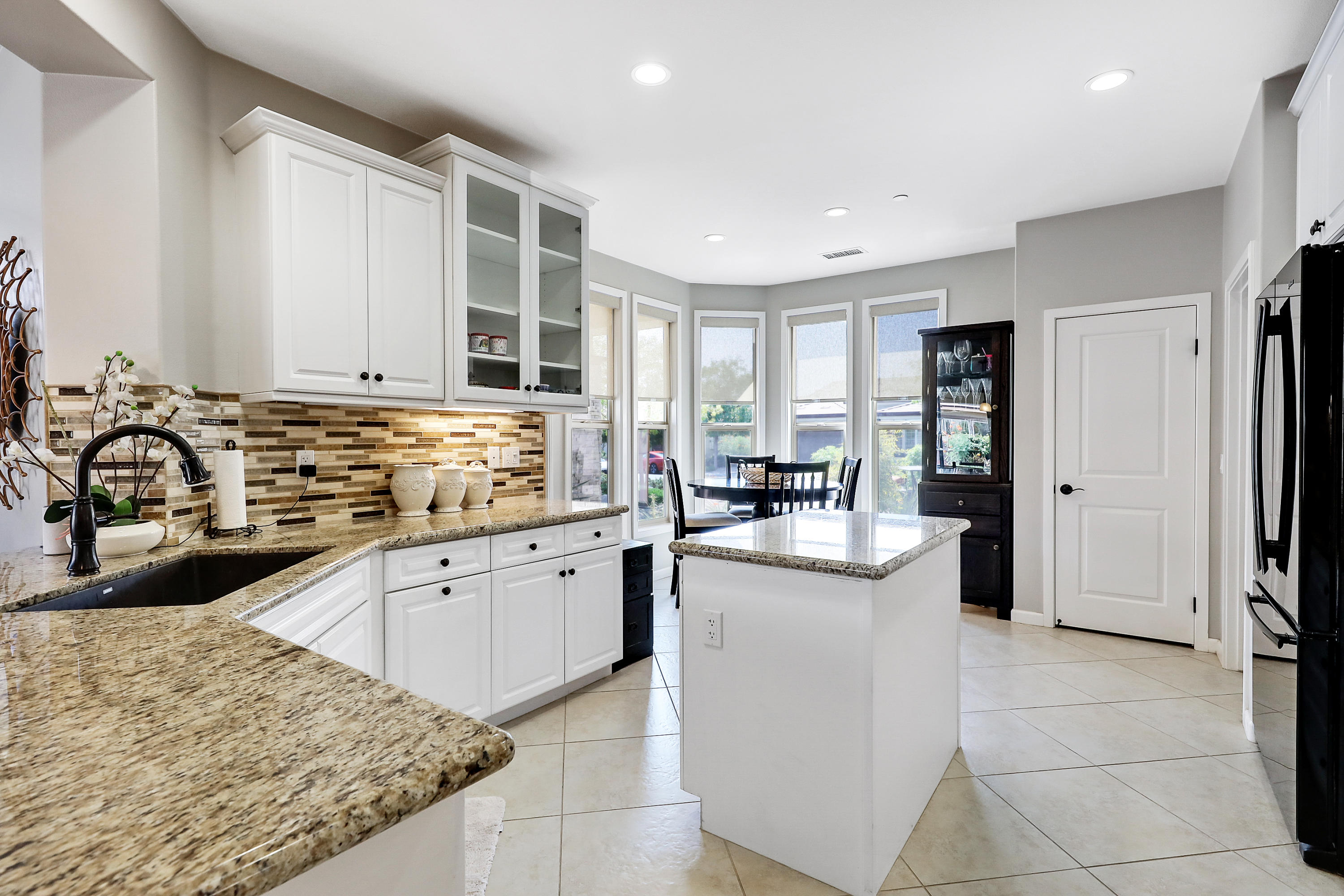 82782 Kingsboro Lane Indio, CA 92201 - Photo 12 of 39 a kitchen with stainless steel appliances granite countertop a sink stove and refrigerator