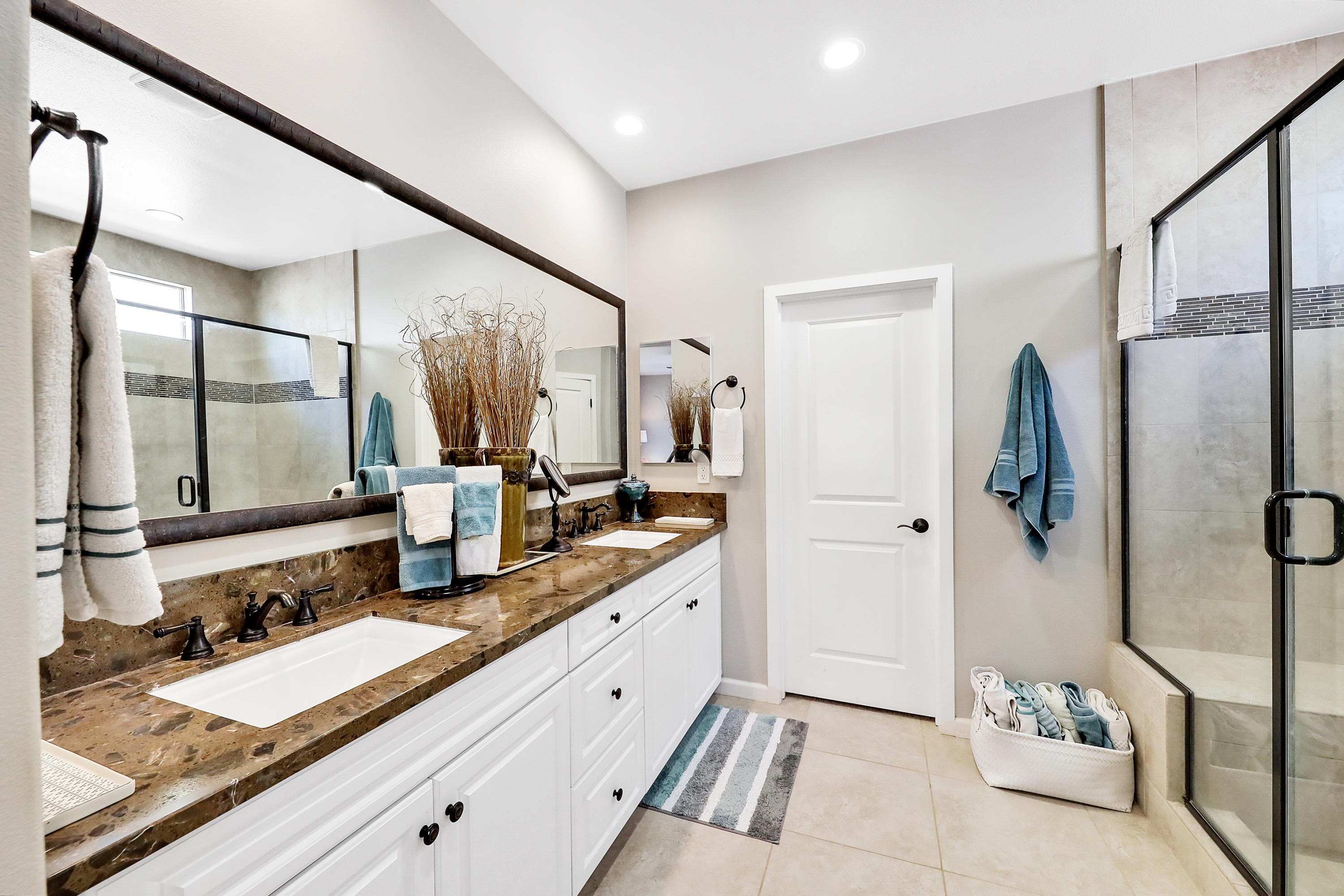 82782 Kingsboro Lane Indio, CA 92201 - Photo 21 of 39 a bathroom with a double vanity sink and mirror with shower