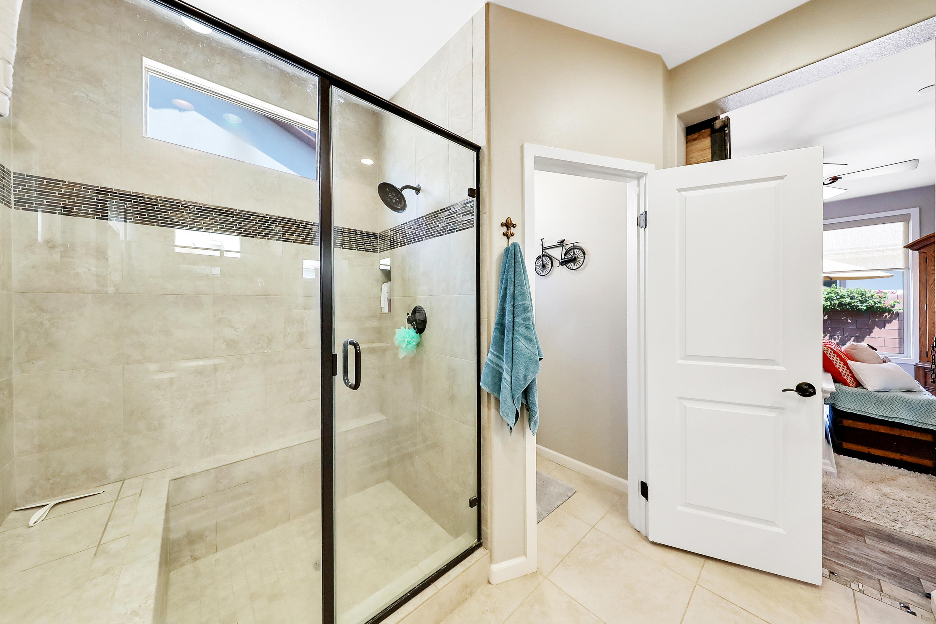 82782 Kingsboro Lane Indio, CA 92201 - Photo 22 of 39 a bathroom with a glass shower door