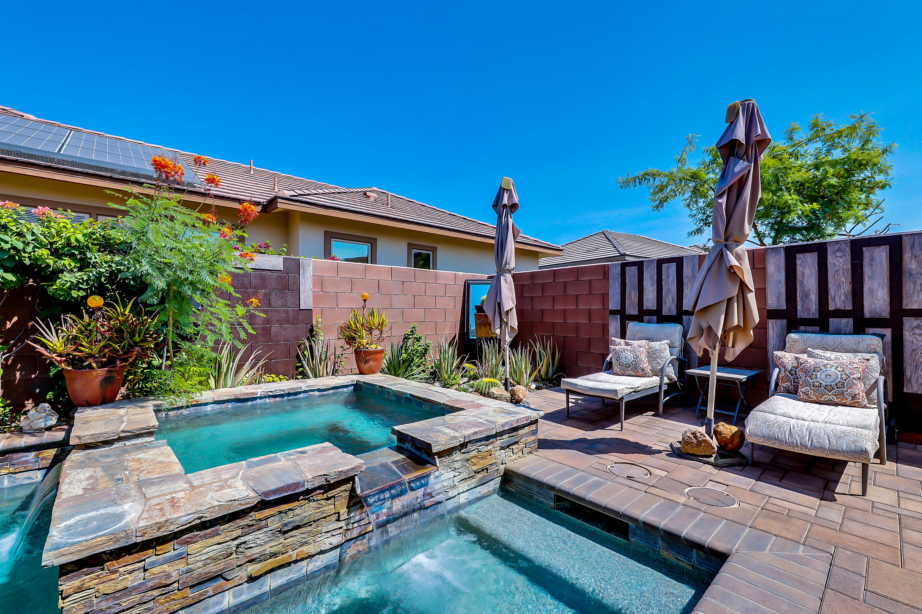82782 Kingsboro Lane Indio, CA 92201 - Photo 26 of 39 a wooden bench sitting in front of a house