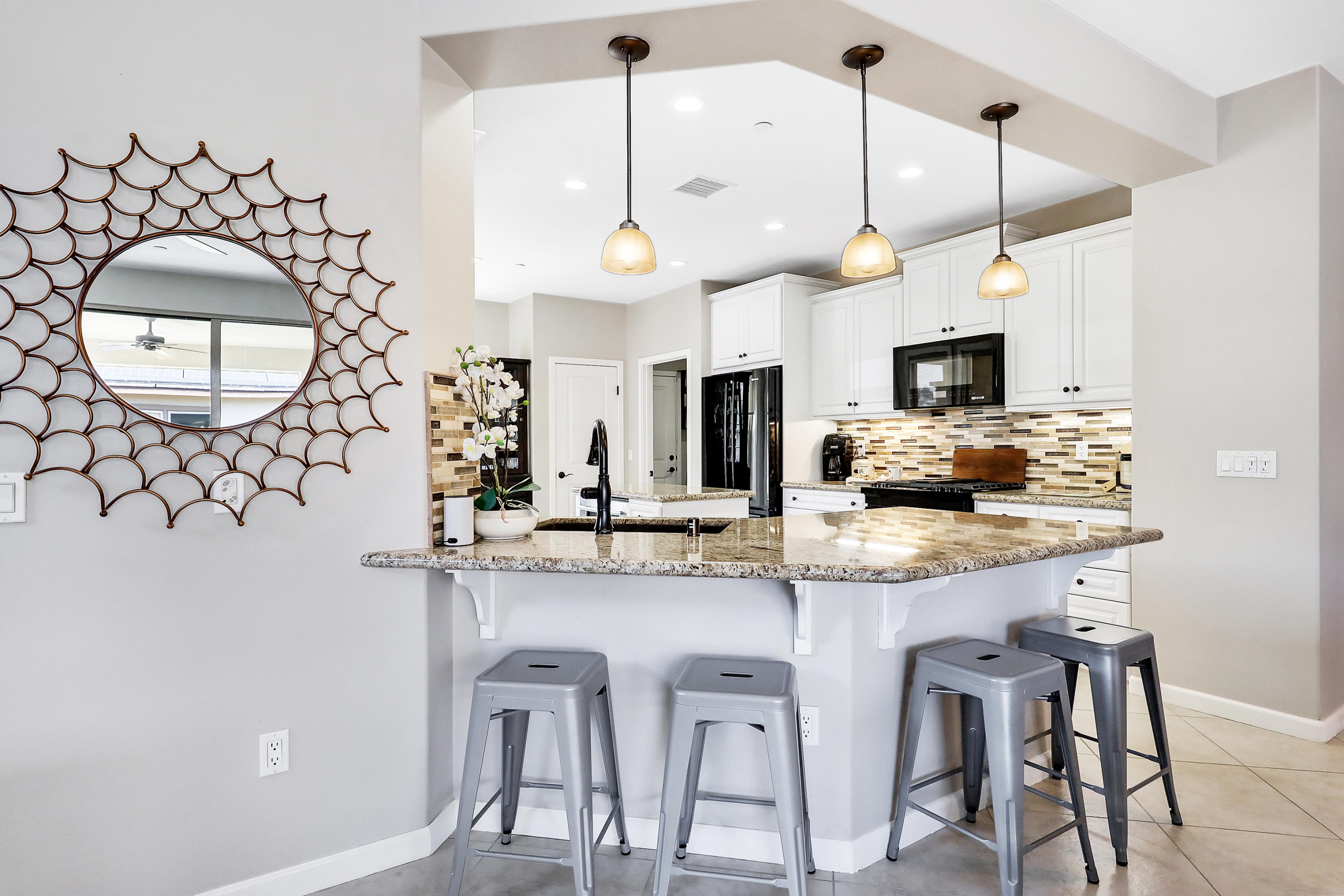 82782 Kingsboro Lane Indio, CA 92201 - Photo 10 of 39 a kitchen with cabinets and chairs