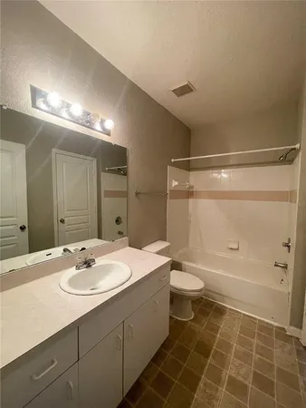 an empty room with a ceiling fan and a window