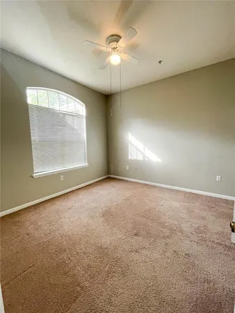 a view of a livingroom with a ceiling fan and window
