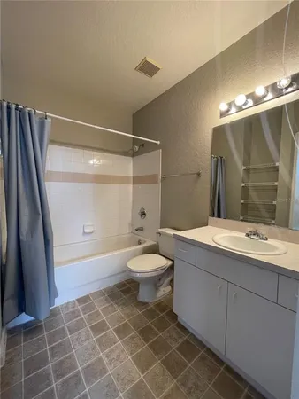 an aerial view of a house with a garden and a yard