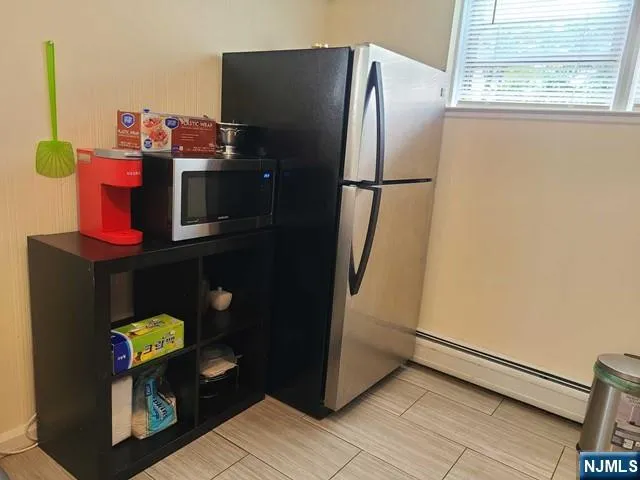 a kitchen with refrigerator and window