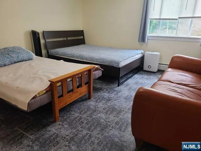 a bedroom with two beds and a window