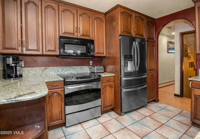 a bathroom with a granite countertop sink mirror vanity and toilet