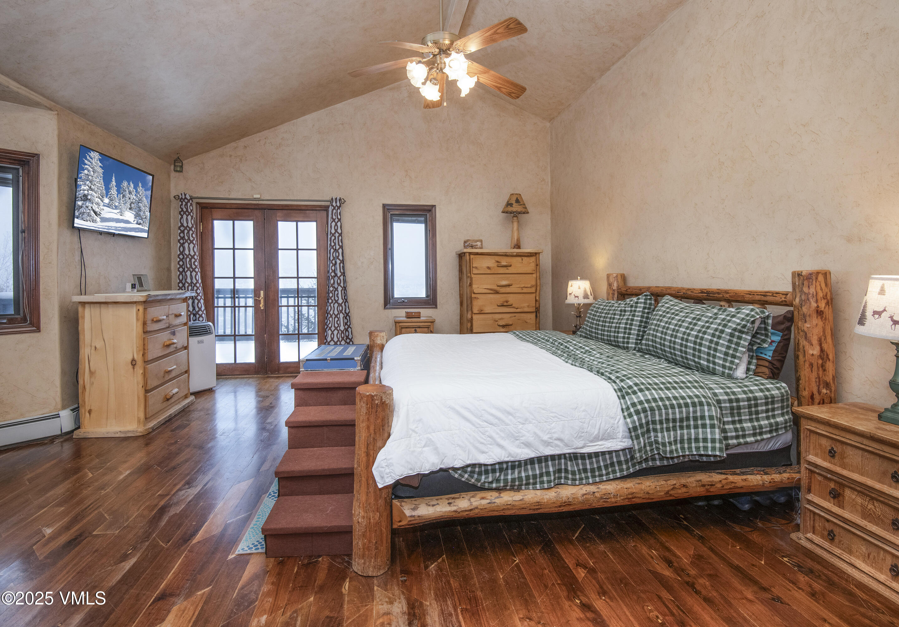 13 Pinion Lane Eagle, CO 81631 - Photo 16 of 60 a bedroom with a bed and wooden floor