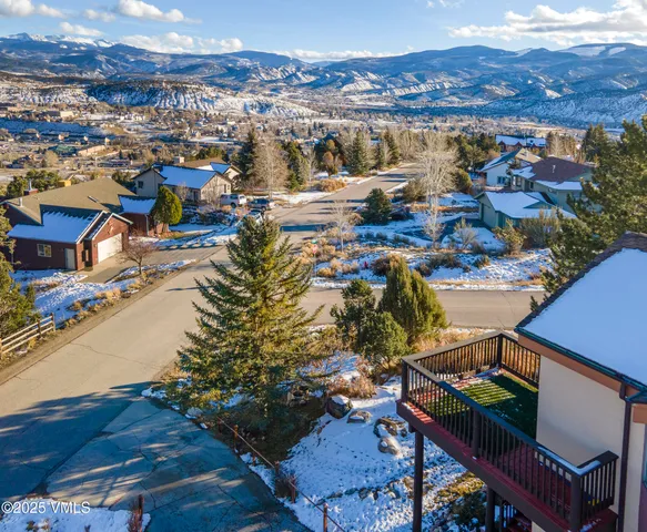a view of a chairs and table in the backyard