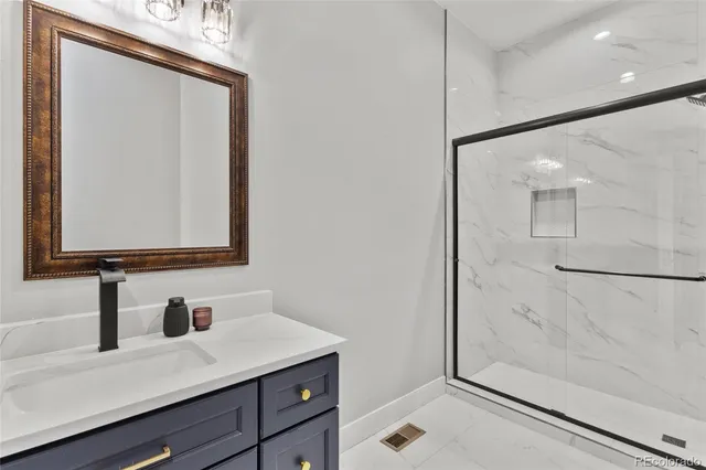 a bathroom with a sink a mirror and a shower