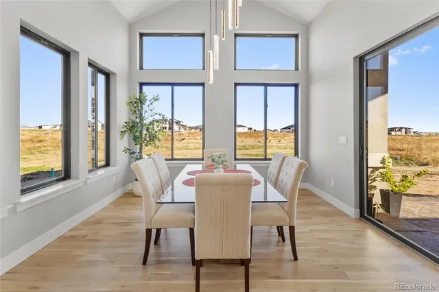 a dining room with wooden floor windows wooden floor and front door