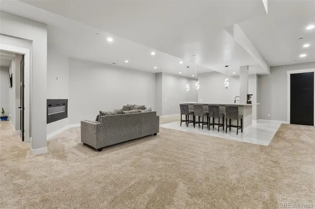 a large white kitchen with kitchen island a stove a table and chairs