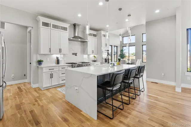 a kitchen with a sink cabinets and wooden floor
